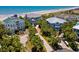 Aerial view showcasing beachfront homes with lush landscaping and private access to the sandy shores at 100 Ocean Park Loop, Georgetown, SC 29440