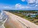 Expansive aerial view of a pristine beach community with private homes, sandy beaches, and blue ocean waters at 100 Ocean Park Loop, Georgetown, SC 29440