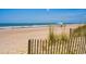 Tranquil beach scene with clear blue waters and a beach tent, ideal for relaxation and coastal living at 100 Ocean Park Loop, Georgetown, SC 29440