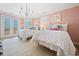 Stylish bedroom with pastel walls, chandelier, and french doors to the balcony at 100 Ocean Park Loop, Georgetown, SC 29440