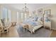 Relaxing bedroom featuring a king bed, ocean views, access to a balcony, and coastal décor at 100 Ocean Park Loop, Georgetown, SC 29440