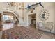 Inviting foyer showcasing high ceilings, staircase, beautiful rug, elegant decor, and a glimpse of the ocean at 100 Ocean Park Loop, Georgetown, SC 29440
