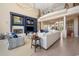 Open living room with tall ceilings, custom shelving, fireplace, lots of comfy seating, and ocean glimpses at 100 Ocean Park Loop, Georgetown, SC 29440
