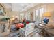 Cozy living room featuring coffered ceilings, large windows, natural lighting, and stylish, comfortable furnishings at 100 Ocean Park Loop, Georgetown, SC 29440