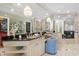 Luxurious main bathroom featuring dual vanities, a makeup counter, a walk-in closet, and lots of natural light at 100 Ocean Park Loop, Georgetown, SC 29440