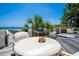 Backyard deck featuring a table, Big Green Egg grill, and relaxing hot tub with stunning ocean views at 100 Ocean Park Loop, Georgetown, SC 29440