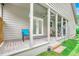 Relaxing back porch featuring brick flooring, white posts, and tranquil views of the landscaped yard at 10056 Kings Rd., Myrtle Beach, SC 29572