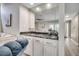 Wet bar featuring granite countertops, white cabinets, and mirrored backsplash for a stylish entertaining space at 10056 Kings Rd., Myrtle Beach, SC 29572