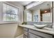 Bathroom featuring a granite countertop, decorative backsplash, and natural light from the window at 10056 Kings Rd., Myrtle Beach, SC 29572