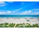 Picturesque ocean and beach view with beachgoers enjoying sunny day under blue skies at 10056 Kings Rd., Myrtle Beach, SC 29572