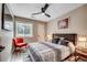 Bright bedroom with a ceiling fan, a vibrant accent chair, and a window with natural light at 10056 Kings Rd., Myrtle Beach, SC 29572