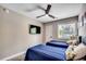 Comfortable bedroom featuring two twin beds, a ceiling fan, a TV, and natural light from the window at 10056 Kings Rd., Myrtle Beach, SC 29572