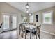 Cozy dining area with wood-look floors, a modern light fixture, and access to the exterior patio at 10056 Kings Rd., Myrtle Beach, SC 29572