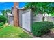 Exterior view of a shed with a neutral siding, brick accents, and mature landscaping at 10056 Kings Rd., Myrtle Beach, SC 29572