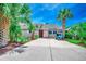 Charming home with a red front door, lush palm trees, and a well-manicured lawn at 10056 Kings Rd., Myrtle Beach, SC 29572