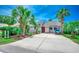 Inviting home with a red front door, palm trees, and a well-maintained driveway at 10056 Kings Rd., Myrtle Beach, SC 29572