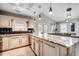 Spacious kitchen with a large island, white cabinets, stainless appliances, and dining area in an open floor plan at 10056 Kings Rd., Myrtle Beach, SC 29572