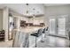 Bright, open kitchen featuring a large island with seating, stainless appliances, white cabinets and pendant lighting at 10056 Kings Rd., Myrtle Beach, SC 29572