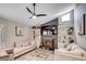 Cozy living room with a brick fireplace, built-in shelves, comfortable sofas, and a modern ceiling fan at 10056 Kings Rd., Myrtle Beach, SC 29572