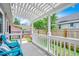Charming patio with white pergola, ideal for relaxing outdoors with comfortable blue seating at 10056 Kings Rd., Myrtle Beach, SC 29572