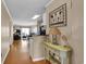 Hallway with wood floors, wall decor, and glimpses of the living room, dining area, and ocean view at 101 W First St. # A2, Ocean Isle Beach, NC 28469