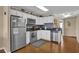 Well-equipped kitchen featuring stainless steel appliances, white cabinetry, and sleek black countertops at 101 W First St. # A2, Ocean Isle Beach, NC 28469