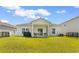 Large backyard features a screened-in porch and privacy fence at 1029 Saltgrass Way, Myrtle Beach, SC 29588