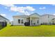 Spacious backyard with a screened-in porch and lush green lawn at 1029 Saltgrass Way, Myrtle Beach, SC 29588