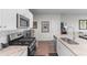 Well-equipped kitchen with stainless appliances, granite counters, white cabinets and an island with bar seating at 1029 Saltgrass Way, Myrtle Beach, SC 29588