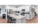Modern kitchen with stainless appliances, granite counters, white cabinets, and an island with bar seating at 1029 Saltgrass Way, Myrtle Beach, SC 29588