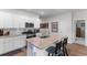 Bright kitchen featuring stainless steel appliances, granite counters, white cabinets, and bar seating at 1029 Saltgrass Way, Myrtle Beach, SC 29588