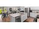 Open kitchen features white cabinets, stainless appliances, large island, and granite countertops at 1029 Saltgrass Way, Myrtle Beach, SC 29588