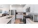 Kitchen boasts stainless steel appliances, white cabinets, granite countertops and hardwood floors at 1029 Saltgrass Way, Myrtle Beach, SC 29588