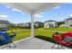 Screened in porch with two chairs and a view of the backyard at 1029 Saltgrass Way, Myrtle Beach, SC 29588