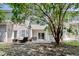 The backyard has a patio with furniture, a small patch of grass, and mature trees providing shade at 105 Spring Creek Dr. # C, Myrtle Beach, SC 29588