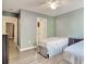 Bedroom featuring two twin beds, hardwood floors, and ensuite bathroom access at 105 Spring Creek Dr. # C, Myrtle Beach, SC 29588