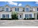 Close-up of townhome featuring well-manicured landscaping and visible unit number at 105 Spring Creek Dr. # C, Myrtle Beach, SC 29588