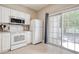 Efficient kitchen with white appliances, lots of cabinet space, and a sliding glass door at 105 Spring Creek Dr. # C, Myrtle Beach, SC 29588