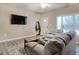Well-lit living room featuring a large television, neutral color palette, and open doorway at 105 Spring Creek Dr. # C, Myrtle Beach, SC 29588