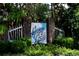 Sign for the 'Spring Creek' neighborhood sits behind brick and wrought-iron entry; lush green landscaping at 105 Spring Creek Dr. # C, Myrtle Beach, SC 29588