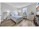 Bedroom with wood floors, full-length mirror, and a window view at 1121 Oxeye St., North Myrtle Beach, SC 29582