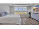Bright, spacious bedroom with hardwood floors, large windows, and modern furnishings at 1121 Oxeye St., North Myrtle Beach, SC 29582