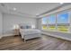 Bright bedroom with hardwood floors, a large bed, and ample natural light at 1121 Oxeye St., North Myrtle Beach, SC 29582
