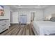 Spacious bedroom with hardwood floors, modern decor, and ensuite bathroom access at 1121 Oxeye St., North Myrtle Beach, SC 29582