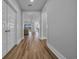 Inviting hallway with wood-look flooring leading to a bright, open living space with views of the outdoors at 1121 Oxeye St., North Myrtle Beach, SC 29582