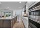 Bright, open kitchen featuring a large island, modern appliances, and hardwood floors at 1121 Oxeye St., North Myrtle Beach, SC 29582