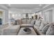 Inviting living space featuring a large sectional sofa and an open layout connecting to the dining and kitchen areas at 1121 Oxeye St., North Myrtle Beach, SC 29582