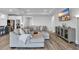 Comfortable living space with a large sectional sofa, adjacent to a modern kitchen and sleek entertainment center at 1121 Oxeye St., North Myrtle Beach, SC 29582