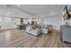 Open-concept living space with a sectional sofa, stylish kitchen, and a dining area under recessed lighting at 1121 Oxeye St., North Myrtle Beach, SC 29582