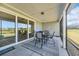 Screened patio with dining table and chairs overlooking the yard at 1121 Oxeye St., North Myrtle Beach, SC 29582